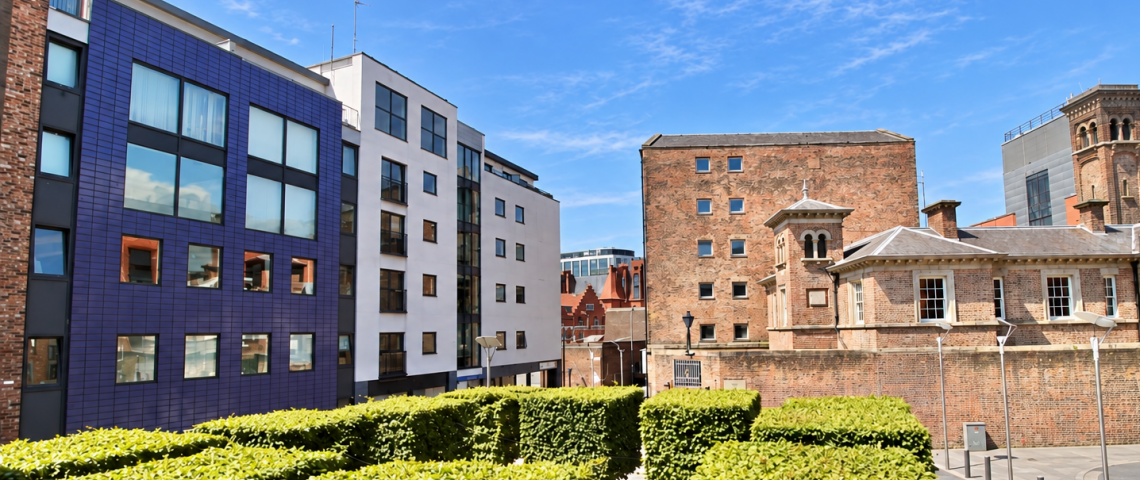 Exterior side view of the apartment building across square